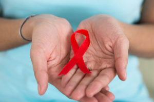 red ribbon in open hands