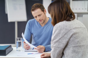 man looking at forms with case worker