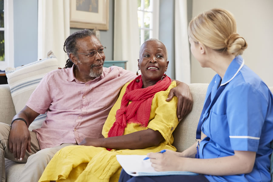 care worker talking to couple