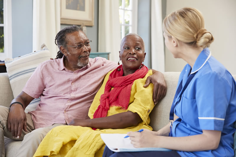 couple on couch talking to case worker