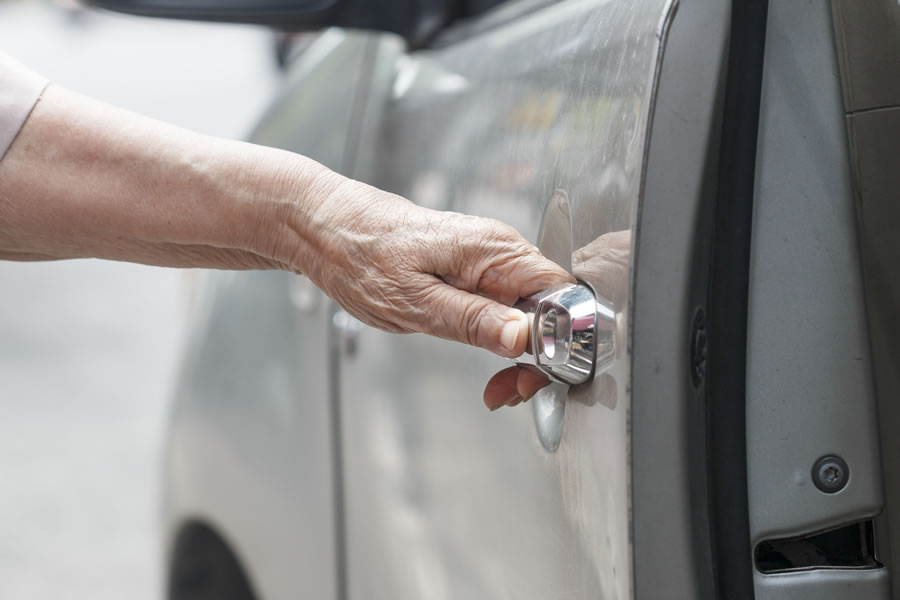 woman holding car door